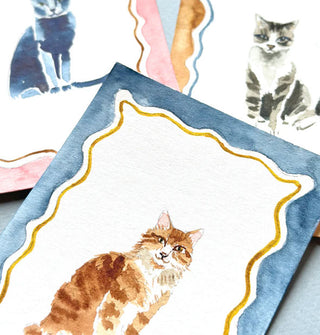 Three completed watercolor cat portraits with wavy borders