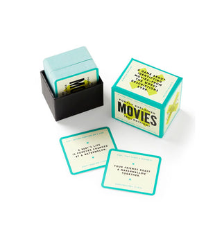 Opened game box of Poorly Explained Movies (80s Edition) with cards visible and two pulled