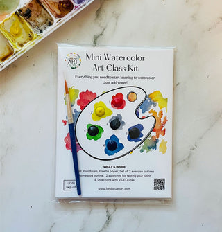 Mini Watercolor Art Class Kit pack on marble tabletop alongside a paint palette