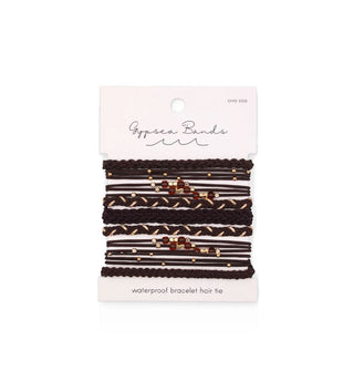 Set of woven Gypsea Bands Waterproof Bracelet Hair Ties in dark brown and gold tones, some of which feature red and gold beads