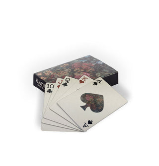 Spread of playing cards with box featuring a dark floral design