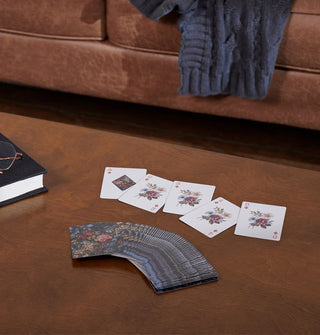 Floral playing cards spread out on a coffee table