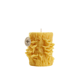 Beeswax candle sculpted to resemble oyster mushrooms on a tree trunk
