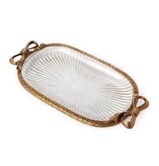 Oval-shaped ribbed glass dish with brass rim featuring bow accents on either side