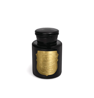 Black apothecary-style candle jar with metallic gold shield-shaped label