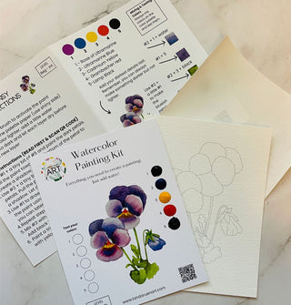Components of a Pansy Watercolor Painting Kit on a marble tabletop