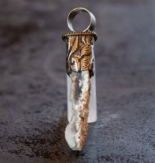 Light-colored orca agate in engraved silver pendant setting with round top bail
