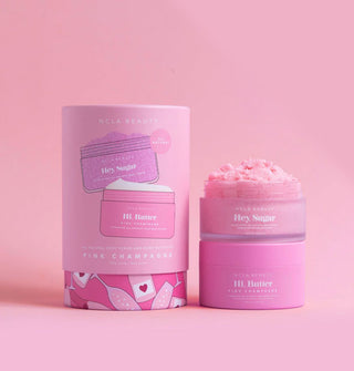 Set of NCLA Beauty Pink Champagne Hey, Sugar body scrub and Hi, Butter body moisturizer jars with pink tube packaging