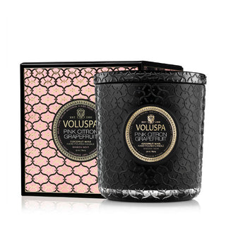 Black glass Pink Citron Grapefruit Voluspa candle jar with textural finish alongside its complementing metallic pink gift box