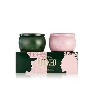 Pink and green patterned Wicked edition Voluspa candle tins with matching gift box featuring silhouettes of Elphaba and Glinda