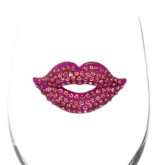 Closeup of the pink jewel-encrusted lips decal on th bowl of a clear wine glass