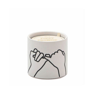White ceramic candle jar features a painted black line drawing of two hands with interlocked pinkies