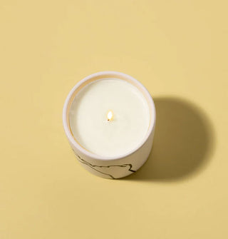 Candle jar with one lit wick shown from above