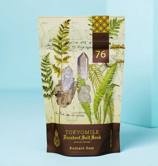 Bag of TokyoMilk Decadent Salt Soak in Radiant Gem scent features metallic gold foil lettering and accents and an illustration of crystals and ferns