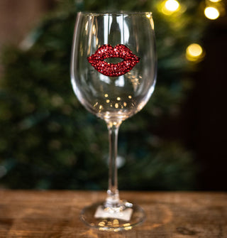 Clear wine glass with red jewel-encrusted lips decal on its bowl