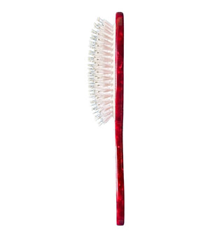 Side view of red hairbrush shows combo bristles