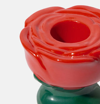 Closeup of the petal details on a red and green ceramic rose taper candle holder