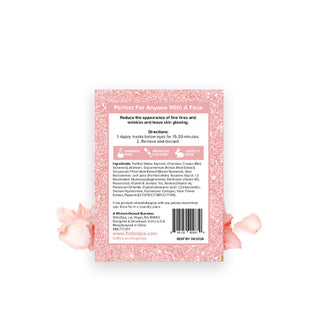Reverse side of ToGoSpa Eyes Rose Gold Tight & Bright Under Eye Masks packet flanked by pink rose petals