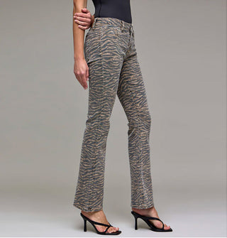 Model wears a pair of flared tiger stripe jeans paired with strappy black heels