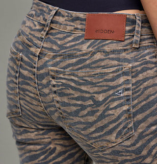 Closeup of back pocket detail on a pair of brown and black iger stripe jeans with brown leather Hidden brand patch