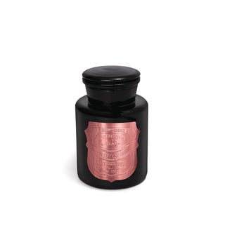 Black apothecary-style candle jar with metallic pink shield-shaped label