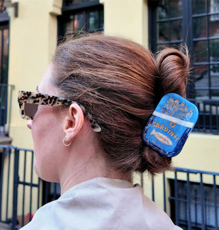 Model wears a sardines tin hair claw in a twist updo