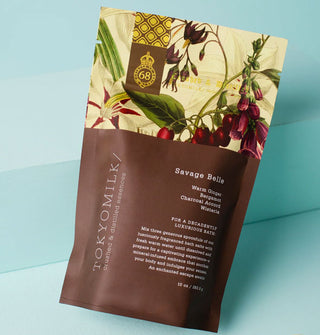 Bag of Savage Belle TokyoMilk bath salts is printed with its key fragrance notes: Warm Ginger, Bergamot, Charcoal Accord, Wisteria