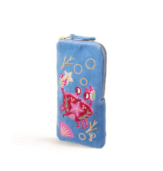 Rectangular periwinkle velvet eyeglass pouch with corner zipper features colorful embroidery depicting a smiling crab holding a starfish in one claw among underwater fauna and bubbles