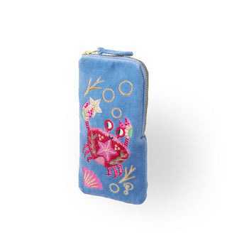 Rectangular periwinkle velvet eyeglass pouch with corner zipper features colorful embroidery depicting a smiling crab holding a starfish in one claw among underwater fauna and bubbles
