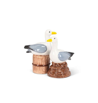 Pair of ceramic salt and pepper shakers, each depicting a perched seagull, one on a piling and one on coiled rope