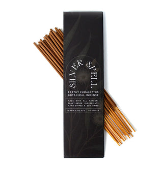 Darkly illustrated rectangular pack of Silver Spell Earthy Eucalyptus Botanical Incense is placed atop a bundle of 20 sticks