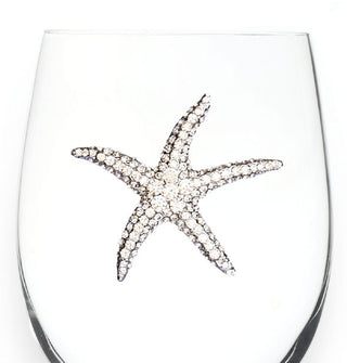 Silver rhinestone-encrusted starfish decal on the bowl of a clear wine glass