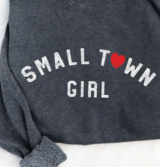 Dark gray sweatshirt that says, "Small town girl" in white lettering with a red heart in place of the "O" in "Town"; its rolled up cuff shows a fleece lining