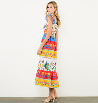 Model wears an A-line style midi length dress with lace-trimmed fluttery cap sleeves and bold color bands featuring flower and animal prints