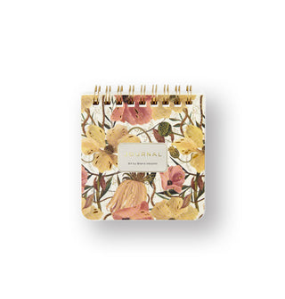 Small square spiral-bound journal features a floral motif in pastel shades of pink, gold, brown, and green