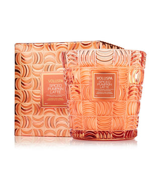 Embossed orange glass Spiced Pumpkin Latte Voluspa candle vessel alongside its matching gift box
