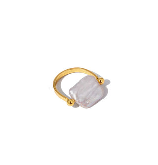 Horseshoe-shaped gold ring with a rectangular pearl set between two ball band ends