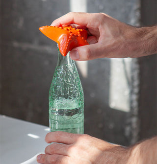 Model removes a bottlecap with an orange starfish-shaped bottle opener
