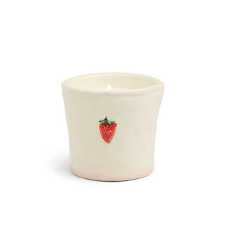 Cream-colored ceramic candle jar with red strawberry accent topped with a green stem