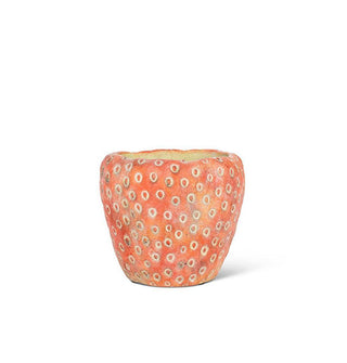 Red cement strawberry-shaped planter with white circular seed details
