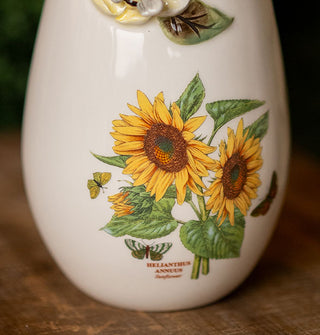 Closeup of the sunflower design on a white ceramic vase, with the caption, "Helianthus annuus"