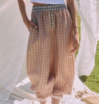 Model wears plaid bloomer-style pants with elasticated, lace-trimmed ankle cuffs