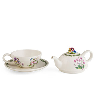 White ceramic tea set: saucer and teacup, with adjacent stackable design teapot, all with floral, vine, and butterfly designs