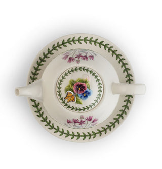 Stacked tea set for one shown from above with green leafy vine borders most prominent, accented by flowers and a figural floral and butterfly lid