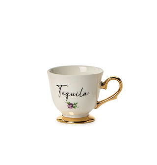 Small porcelain teacup with gold base and handle says, "Tequila" in black script with a small flower design underneath