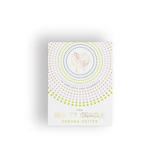 White box of The Beauty Oracle cards by Sakura Sutter with multicolored radial dot pattern around a central gold foil symbol