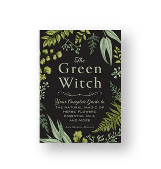 Black cover of The Green Witch: Your Complete Guide to the Natural Magi of Herbs, Flowers, Essential Oils, and More features green title lettering and lush green botanical illustrations around the border