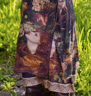 Detail of a Joan of Arc portrait at the bottom of a kimono-style robe with side slit