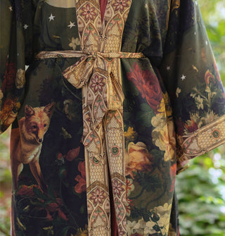 Model wears a kimono-style robe with fox and floral themes complemented by a printed border and tied fabric belt