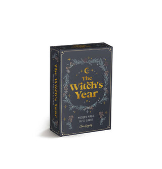 Dark gray box of The Witch's Year cards with gold title lettering surrounded by delicate pastel floral artwork